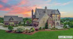 an aerial view of a large home in the evening