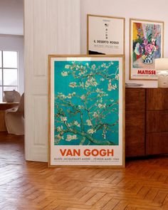 there is a van gogh poster in the corner of this room with wood floors and white walls