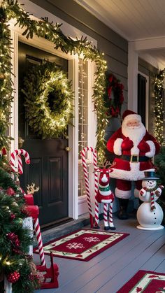 a santa clause standing in front of a house decorated for christmas