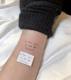 a person's arm with a note attached to it that says, i love you