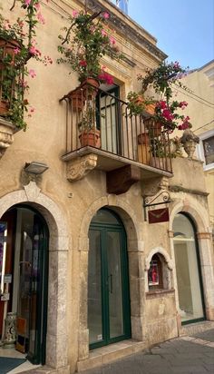 an old building with flowers on the balconies