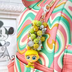 a close up of a bag with beads on it and a keychain attached to the back