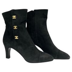 - Chanel black suede ankle boots. A classic collectable item! - Gold Hardware CC turn-lock style. - Side zip closure. - Size 37. Luxury Black Heeled Boots, Chic Luxury Boots With Zipper Closure, Luxury Boots With Buttons And Round Toe, Chic Luxury Boots, Luxury Black Boots For Work, Luxury Winter Ankle Boots, Luxury Elegant Boots With Leather Trim, Chic Fitted Luxury Boots, Chic Luxury Ankle Boots