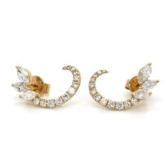 pair of gold tone earrings with clear stones on each side and small leaves in the middle