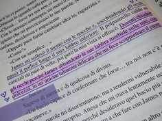 an open book with purple and black lines on it's page, in spanish