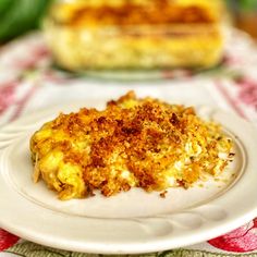 a white plate topped with food next to a casserole dish