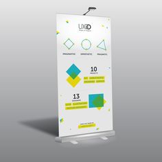 a white roll up banner with yellow and blue shapes