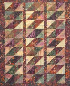 a quilt with many different colors and patterns on the front, one is multicolored