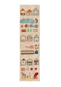 a white wall hanging with houses and buildings on it