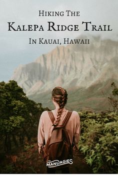 a woman with braids standing in front of a mountain and looking into the distance