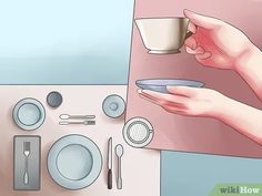 a person holding a plate with a cup on it next to plates and utensils