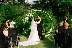 a bride and groom standing under an arch at their wedding ceremony