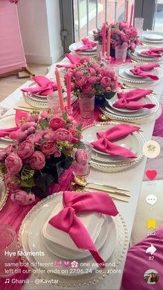 the table is set with pink flowers and place settings