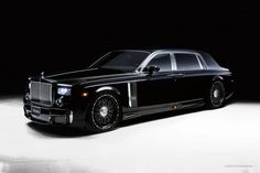 a black rolls royce parked in the dark