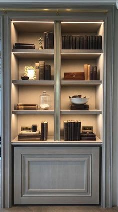 an open book case with books and other items on it's shelves in a room