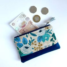 a purse with money and coins sitting next to it