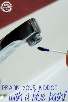 a person is holding a toothbrush in their hand and cleaning it with water from the faucet