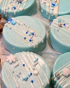 blue and white decorated cookies sitting on top of a counter