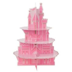 a pink castle shaped cake stand on top of a white table