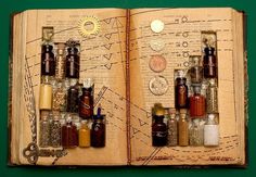 an open book with lots of bottles on top of it and some coins in the bottom