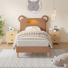 a bedroom with a bed, nightstands and a teddy bear head on the wall