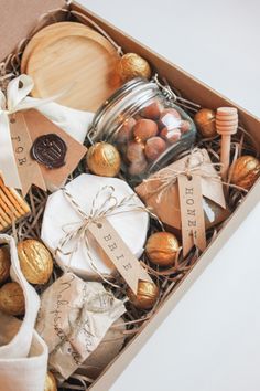 a gift box filled with chocolates, cookies and other treats for someone's special occasion