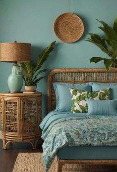 a bed with blue sheets and pillows in a bedroom next to a wicker nightstand