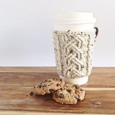 two cookies and a cup of coffee on a wooden table