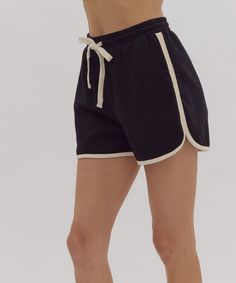 These soft and comfortable dolphin shorts feature a high waistline, self-tie at an elasticized waist and contrasting solid trim. Pair with the matching top for a chic set look or throw on with your favorite tee for lounge days or days on the go. 50% cotton, 43% polyester, 7% spandex Unlined, knit, non-sheer, lightweight Model is wearing a size small and is 5'10" FINAL SALE - CANNOT BE RETURNED OR EXCHANGED Casual Short Bottoms With Contrast Trim, Athleisure Bottoms With Contrast Trim For Loungewear, Black Summer Shorts For Loungewear, Summer Cotton Shorts With Contrast Color, Cotton Shorts With Contrast Color For Summer, Cotton Shorts With Contrast Trim, Cotton Shorts With Contrast Trim For Summer, Summer Loungewear Bottoms With Contrast Trim, Summer Athleisure Shorts With Contrast Trim