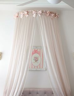 a pink canopy bed in a girls'bedroom