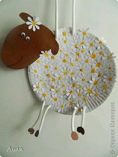 a plate with a brown sheep on it and a white plate with flowers around it