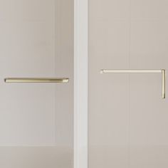 two white doors with brass handles in a bathroom setting, one closed and the other open