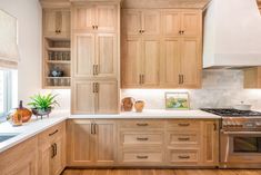 a kitchen with wooden cabinets and white counter tops, along with an oven in the center