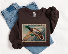 Duck hunting, duck hunter, duck hunter girlfriend, duck hunter wife, duck season, hunting wife, oversized boyfriend, hunting season, retro crewneck, vintage crewneck, gifts for duck hunter Ideal for any situation, a unisex heavy blend crewneck sweatshirt is pure comfort. These garments are made from polyester and cotton. This combination helps designs come out looking fresh and beautiful. The collar is ribbed knit, so it retains its shape even after washing. There are no itchy side seams on these sweaters.  .: Made with a medium-heavy fabric blend of 50% cotton and 50% polyester (8.0 oz/yd² (271.25 g/m this sweatshirt feels cozy and is the perfect choice for those colder months. .: The classic fit along with the crew neckline deliver a comfy wearing experience with a clean-cut style. Meanw Duck Clothing, Duck Sweater, Hunting Outfit, Retro Crewneck, Duck Stamp, Boyfriend Sweatshirt, Duck Season, Duck Hunter, Crewneck Vintage