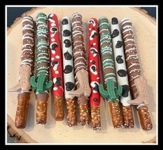 several different types of candy sticks on top of a wooden board