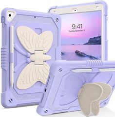 an ipad case with a butterfly design on the front and back cover, attached to a stand