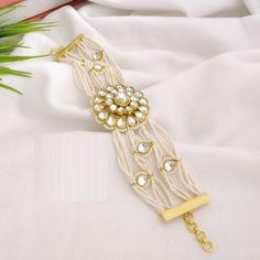 Kundan Pearl Chain bracelet/ Indian Kundan Bracelet / Indian Pearl Statement bracelet/ Kundan bracelet/ Gold plated Indian Bridal Bracelet Features Traditional Kundan/Pearls bracelet Handcrafted To Perfection Light Weight Perfect For Indian Weddings And Celebrations A Beautiful & Memorable Gift for Weddings and Special Occasions Available in size 2.6,2.8,2.10 Facebook: www.facebook.com/shoparyafashions Pinterest: www.pinterest.com/aryafashions Instagram: www.instagram.com/shoparyafashions Twitte Adjustable Metal Bracelet For Celebration, Adjustable Metal Bracelets For Celebration, Traditional White Metal Bracelet, Traditional White Bracelets For Celebration, White Bracelets For Party And Festivals, Adjustable White Pearl Bracelet For Festive Occasions, Beaded Bracelet Jewelry For Celebration, Festive Adjustable White Pearl Bracelet, White Bracelet Strap Jewelry For Wedding