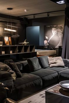 a living room filled with black furniture and lots of pillows on top of it's couches