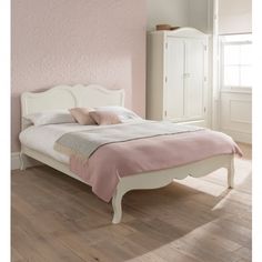 a bedroom with pink walls and white furniture