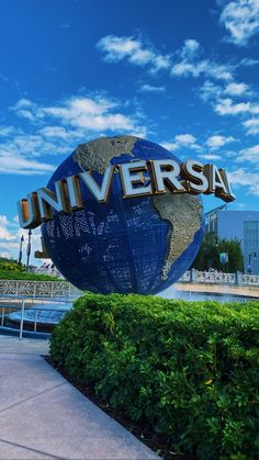 the universal sign is surrounded by bushes and trees