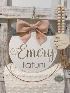 a wooden sign that says, merry tatum with a bow hanging from it