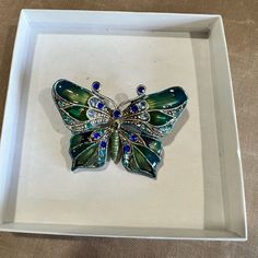 Nib Beautiful Butterfly Brooch With Jade Colored Stones And 2 Shades Of Blue Accenting The Wings In Enamel Setting. Elegant Blue Butterfly Brooches, Colored Stones, Butterfly Brooch, The Wings, Blue Accents, Beautiful Butterflies, Shades Of Blue, Stone Color, Brooches