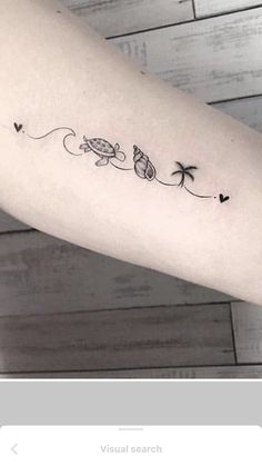 a woman's arm with a small turtle and palm trees tattoo on the left forearm