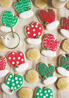 decorated cookies are arranged in the shape of hearts and cactuses on a wooden table