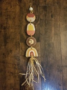 a wall hanging made out of wood with various items attached to the top of it