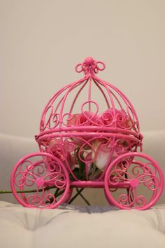 a pink carriage with flowers in it