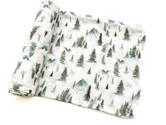 a folded napkin with trees printed on it