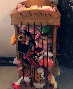 a wooden crate filled with lots of stuffed animals in it's cage and labeled azkaban