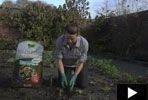 a man is kneeling down in the dirt