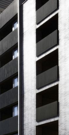 an apartment building with two balconies on the side and one in the middle